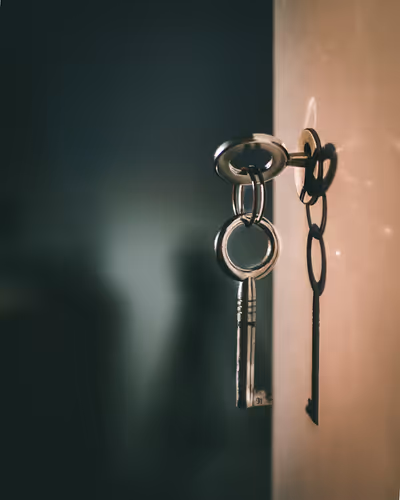 Hanging key in a keyhole with a blurred background